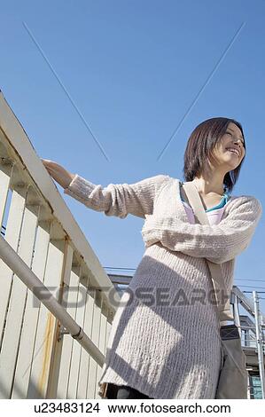 Picture - Woman below the blue sky. Fotosearch