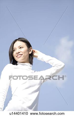 Woman below the blue sky View Large Photo Image Stock Image - Woman below the blue sky. Fotosearch
