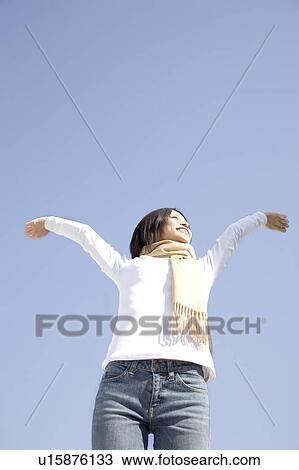 Woman below the blue sky View Large Photo Image Stock Image - Woman below the blue sky. Fotosearch