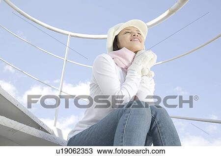Stock Image - Woman below the blue sky. Fotosearch
