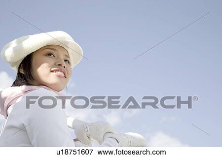 Stock Photo - Woman below the blue sky. Fotosearch