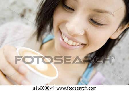 Stock Image - Woman drinking Cafe latte. Fotosearch
