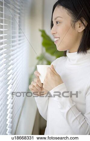 Woman gripping a coffee cup View Large Photo Image Stock Image - Woman gripping a coffee cup. Fotosearch