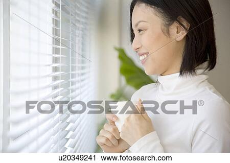 Woman gripping a coffee cup View Large Photo Image Stock Image - Woman gripping a coffee cup. Fotosearch