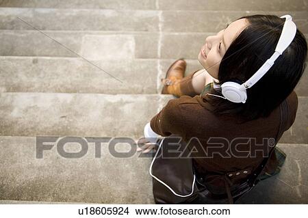Picture - Woman listening to music. Fotosearch