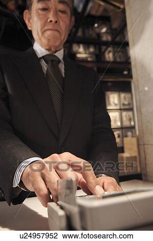 Stock Image - Executive pushing a button. Fotosearch