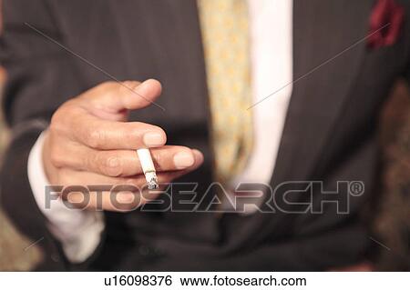 Stock Photograph - Hand having a tobacco. Fotosearch