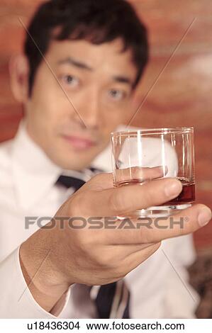 Office worker having a whiskey View Large Photo Image Picture - Office worker having a whiskey . Fotosearch