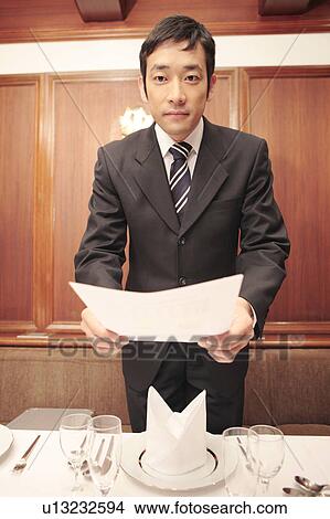 Picture - Office worker trying to hand a document. Fotosearch