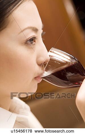 Stock Photo - Woman drinking wine. Fotosearch