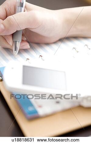 Stock Image - Hand taking a memo. Fotosearch