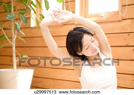 Stock Image - Japanese woman doing exercise. Fotosearch
