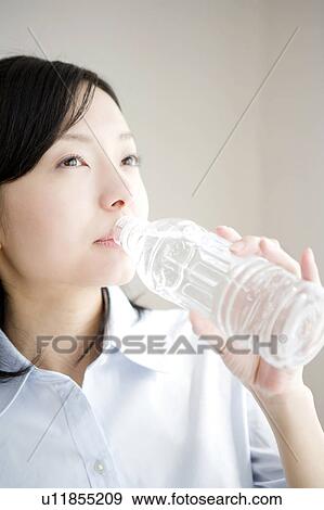 Stock Photo - Japanese woman drinking a water. Fotosearch