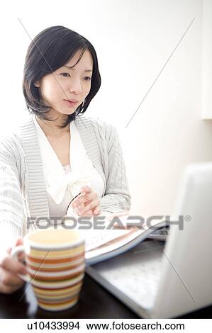 Japanese woman operating a PC View Large Photo Image Picture - Japanese woman operating a PC. Fotosearch