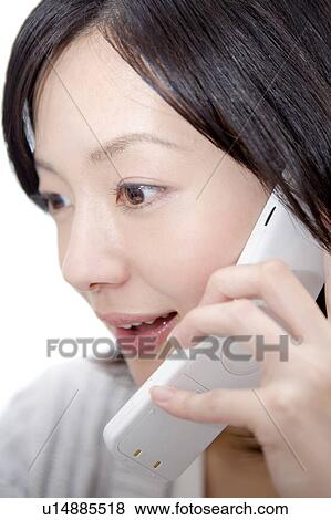 Stock Photo - Office woman talking on a cell phone. Fotosearch
