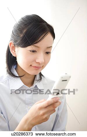 Woman holding cell phone View Large Photo Image Stock Image - Woman holding cell phone. Fotosearch