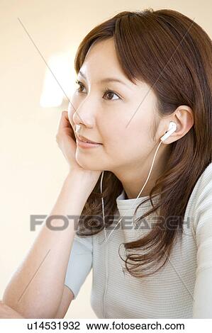 Stock Image - Woman listening to music. Fotosearch