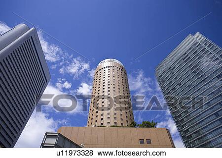 Stock Photo - Low angle of skyscrapers against the sky. Fotosearch