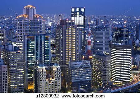 Stock Image - Skyscrapers downtown at night. Fotosearch