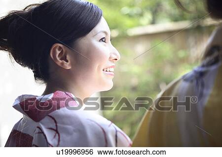 Back figure of Japanese woman putting on a yukata View Large Photo Image Stock Photograph - Back figure of Japanese woman putting on a yukata. Fotosearch