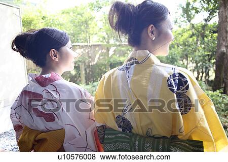 Stock Photo - Back figure of Japanese women putting on a yukata. Fotosearch