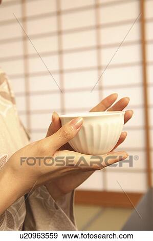 Hand of woman having a teacup View Large Photo Image Stock Photo - Hand of woman having a teacup. Fotosearch