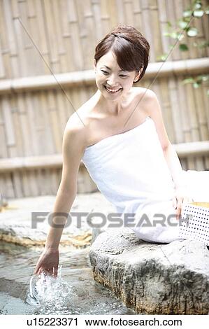 Stock Image - Japanese woman at the open-air bath. Fotosearch