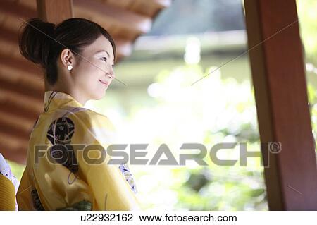 Japanese woman putting on a yukata View Large Photo Image Stock Image - Japanese woman putting on a yukata. Fotosearch