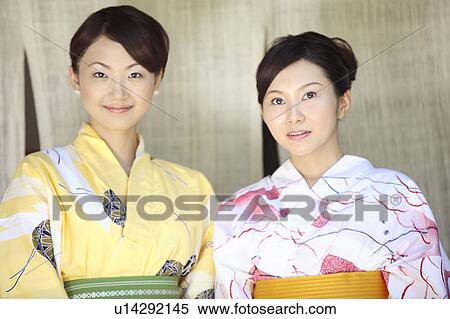 Stock Photography - Japanese woman putting on a yukata. Fotosearch