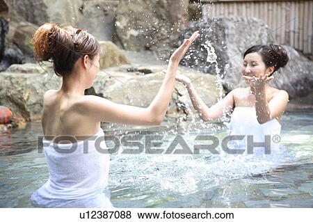Stock Photo - Japanese women in a open-air bath. Fotosearch
