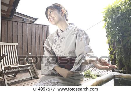 Woman scooping the water of a spring View Large Photo Image Stock Photo - Woman scooping the water of a spring. Fotosearch