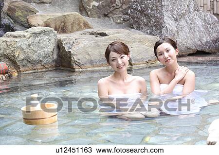 Stock Image - Women in an open-air bath. Fotosearch