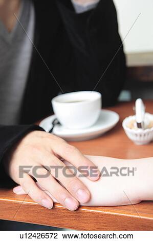 Stock Image - Hands on the table. Fotosearch