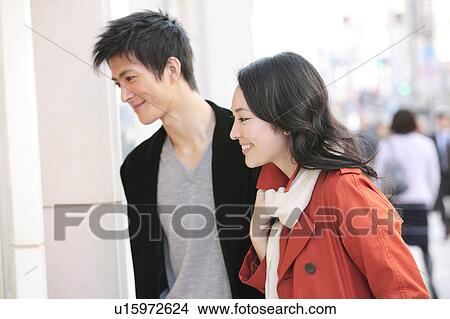 Japanese young couple enjoy window shopping View Large Photo Image Picture - Japanese young couple enjoy window shopping. Fotosearch