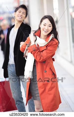 Japanese young woman pulling boyfriend's hand View Large Photo Image Stock Image - Japanese young woman pulling boyfriend's hand. Fotosearch