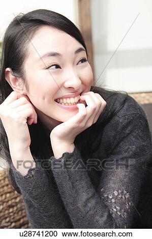 Stock Image - Smiling Japanese young woman. Fotosearch