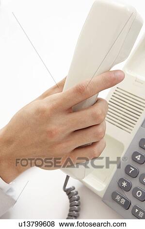 Hand having a receiver of a phone View Large Photo Image Stock Photo - Hand having a receiver of a phone. Fotosearch