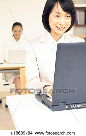 Office lady operating a PC View Large Photo Image Picture - Office lady operating a PC. Fotosearch
