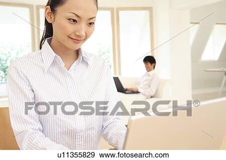 Stock Photo - Office lady operating a PC. Fotosearch