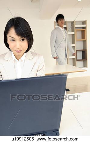 Stock Photography - Office lady operating a PC. Fotosearch