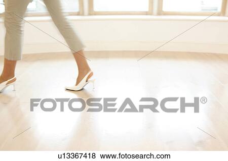 Stock Photo - Office lady walking in a room. Fotosearch