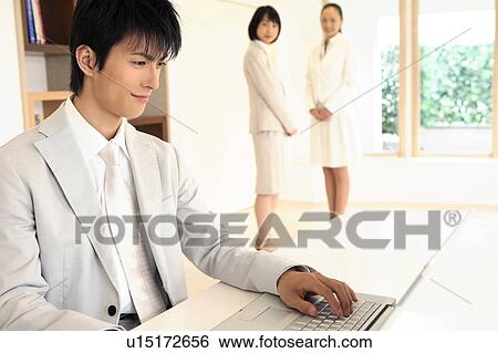 Office worker operating a PC View Large Photo Image Stock Photograph - Office worker operating a PC. Fotosearch