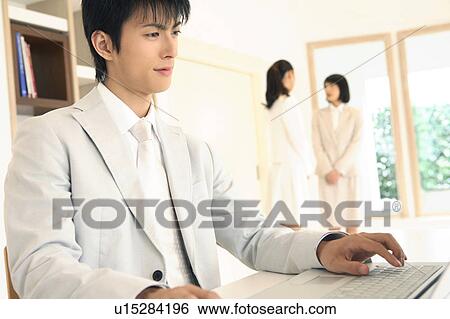Office worker operating a PC View Large Photo Image Stock Photograph - Office worker operating a PC. Fotosearch