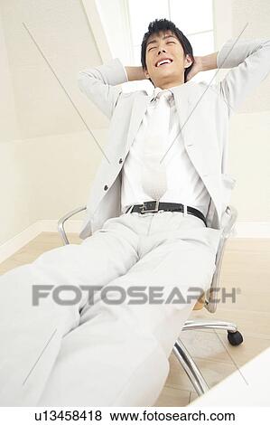 Office worker riding his foot on a desk View Large Photo Image Stock Photo - Office worker riding his foot on a desk. Fotosearch