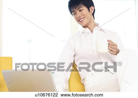 Stock Image - Office worker taking a rest. Fotosearch