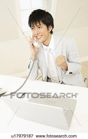 Stock Photo - Office worker talking with phone. Fotosearch