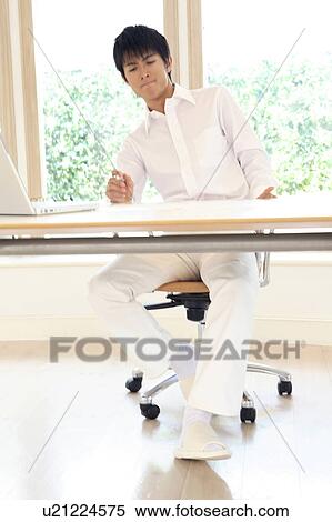 Stock Photography - Office worker thinking about something. Fotosearch