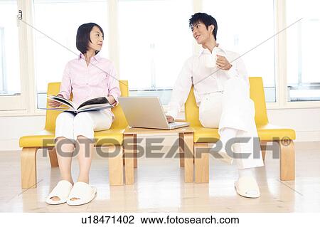 Stock Image - Office workers sitting on a chair. Fotosearch