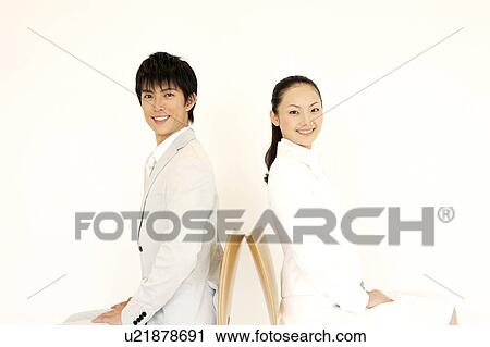 Stock Image - Office workers sitting on a chair. Fotosearch