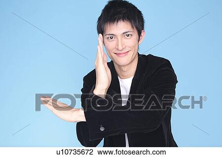 Stock Image - Man posing his arms cross-shaped. Fotosearch